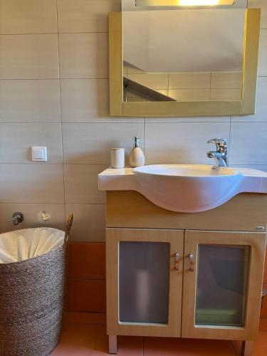 a bathroom with a sink and a mirror at Nea Makri Holiday Villa in Nea Makri