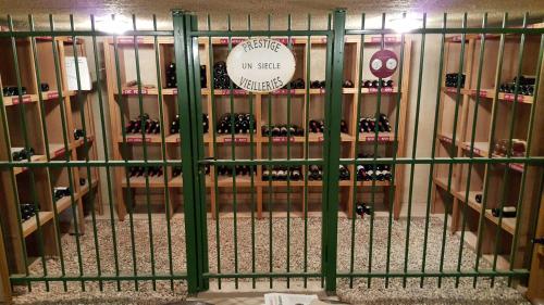 a room filled with lots of bottles of wine at Hotel Restaurant La Martiniere in Montélier