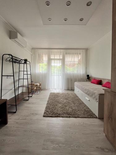 a bedroom with a bed and a ladder in it at Maros Apartman in Makó