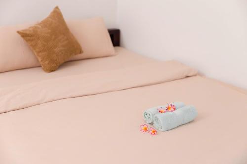 a white bed with a small toy on it at Green homestay, Huế in Hue