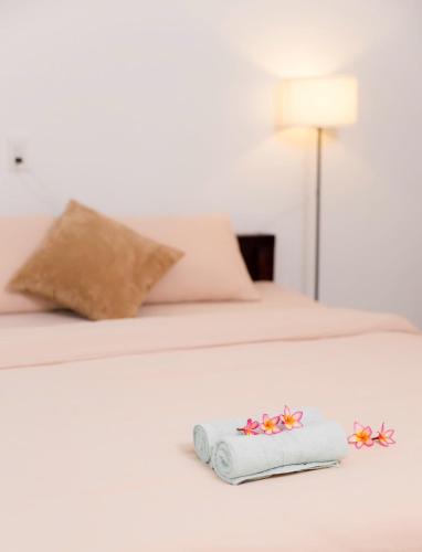 a bed with two beds with a towel on it at Green homestay, Huế in Hue