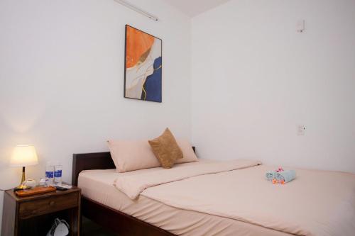 two beds sitting next to each other in a room at Green homestay, Huế in Hue