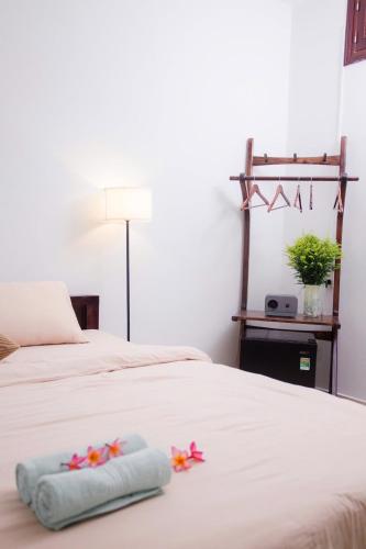 a bedroom with a bed with flowers on it at Green homestay, Huế in Hue