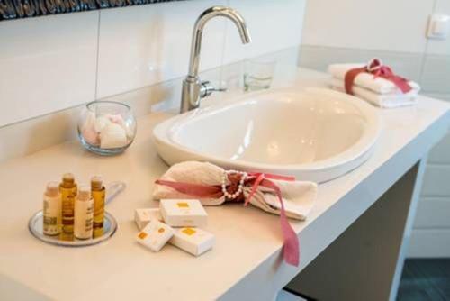 a bathroom counter with a sink and a white sink at Villa Kokalis Resort hotel in Gouves
