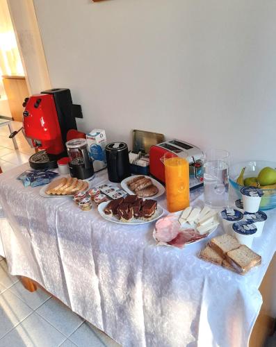 a table with plates of food on it at Aromatika, b&b, affittacamere in Faenza