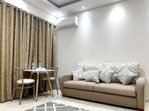 a living room with a couch and a table at El Lotus Building in Cairo