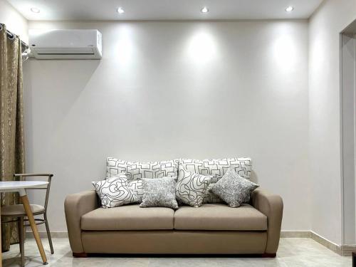 a living room with a couch in front of a wall at El Lotus Building in Cairo