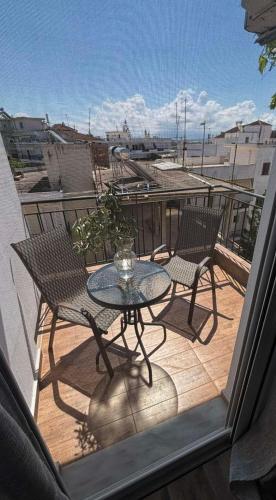 a patio with a table and chairs on a balcony at SPN.SPIROS APARTMENTS PREVEZA in Preveza