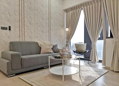 a living room with a couch and a table at Suites Apartment By Star Residences in Kuala Lumpur