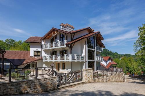 a building with balconies on the side of it at Molfar Resort Hotel & SPA Карпати in Shaian