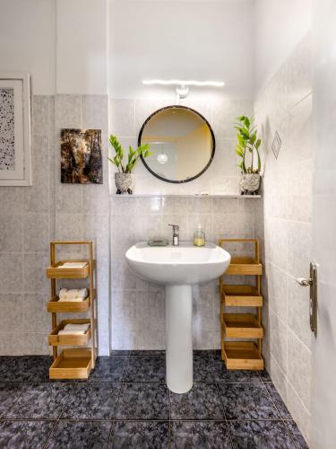 a bathroom with a sink and a mirror at Mira Seaside Residence in Kalívia Thorikoú