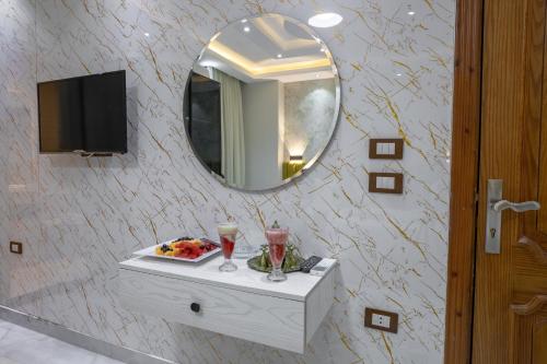 a bathroom with a table with a plate of food and a mirror at The Muse Luxury View Hotel in Cairo
