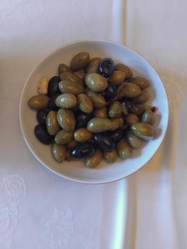 a white bowl filled with olives on a table at Eta's Manor @ Brooklands in Maryport