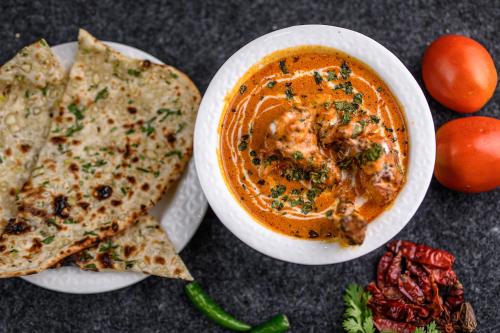 a bowl of soup next to a plate of food at Best Western Plus Revanta Mcleod Ganj in Dharamshala