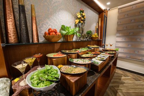 a buffet line with many different types of food at Best Western Plus Revanta Mcleod Ganj in Dharamshala
