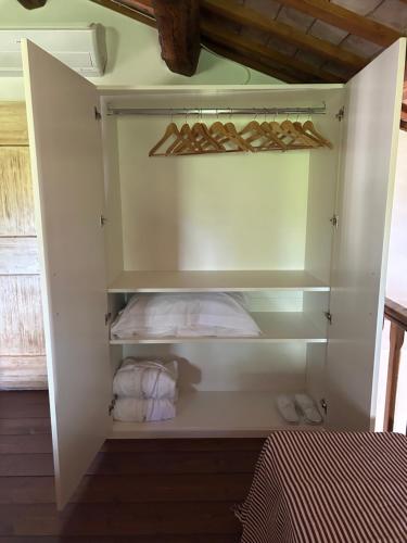a white cabinet with some towels in it at Casa Sant Angelo in Pesaro