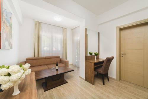 a living room with a couch and a table at Hotel 219 Budva in Budva