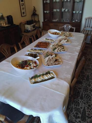 a long table with many plates of food on it at Eta's Manor @ Brooklands in Maryport