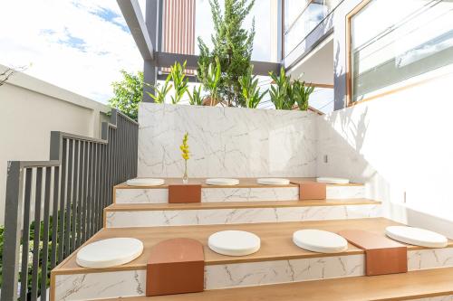 a set of stairs with white plates on them at Meraki Villa Đà Lạt in Khu Chi Lăng