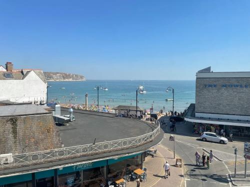 a view of a street with the ocean in the background at Apartment - Centre of Swanage Stunning Sea views in Swanage