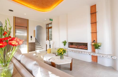 a living room with a couch and a fireplace at Meraki Villa Đà Lạt in Khu Chi Lăng