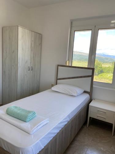 a bedroom with a bed and a window at Montebello Inn apartments in Ulcinj
