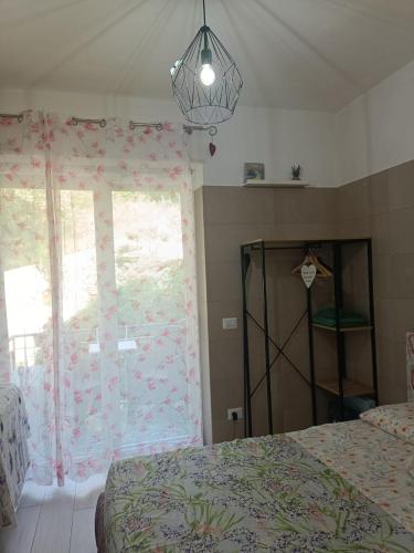 a bedroom with a bed and a window with a curtain at Appartamento Lavanda Garda in Garda
