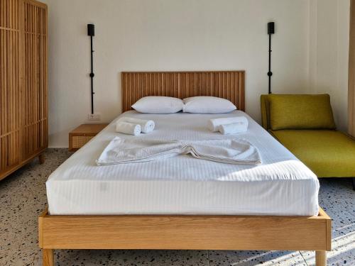 a bedroom with a bed with two towels on it at Fengari Ada Evi in Gökçeada