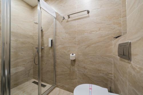 a bathroom with a shower and a toilet at Hotel 219 Budva in Budva