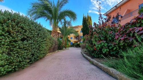 a street with a palm tree and a building at CSS Cheerful Smart Superior 2BD Townhouse Limnaria Gardens in Paphos City