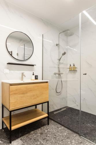 a bathroom with a sink and a shower at Loka Residence in Kavala