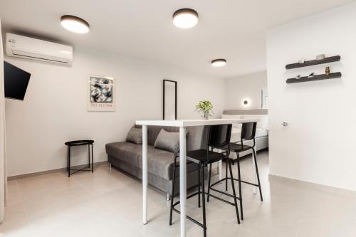a living room with a table and a couch at Loka Residence in Kavala