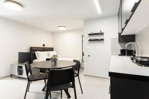 a kitchen and dining room with a table and chairs at Loka Residence in Kavala
