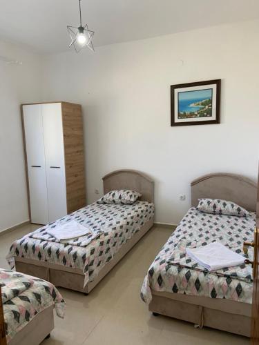 a bedroom with two beds and a picture on the wall at Montebello Inn apartments in Ulcinj