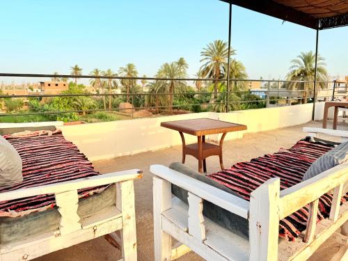 two beds and a table on a roof at White Gorf Hotel in Luxor