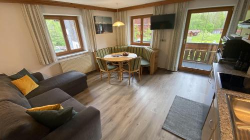a living room with a couch and a table at Haus Brandhofer in Häselgehr