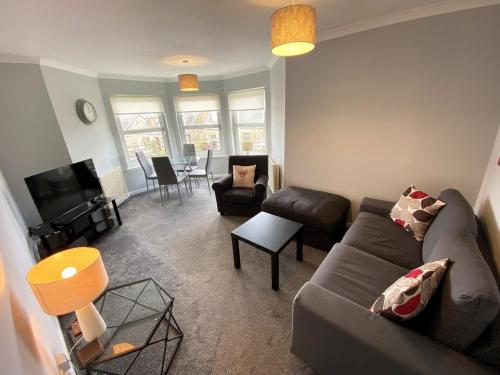 a living room with a couch and a table at NEW Super 2 Bedroom Flat in Falkirk in Falkirk