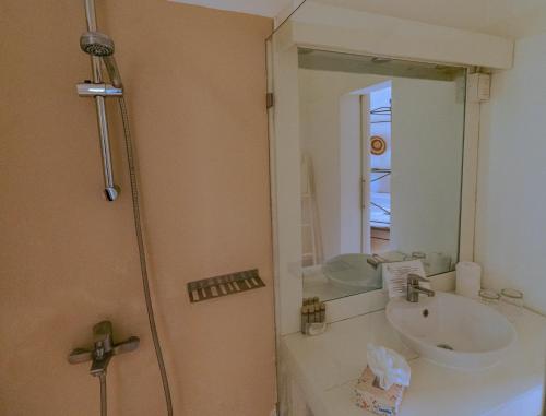a bathroom with a sink and a mirror at Hotel Atlantis in Las Terrenas
