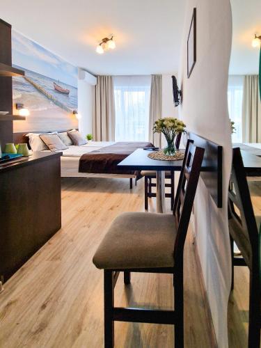 a bedroom with a bed and a table with a chair at Villa Sarema in Chłopy