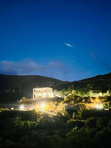 a large building on a hill with lights on at Villa Christoforos Kekakos Magical View in Neapolis