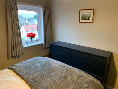 a bedroom with a bed and a window at Superb One Bedroom Getaway in Dysart Kirkcaldy in Kirkcaldy