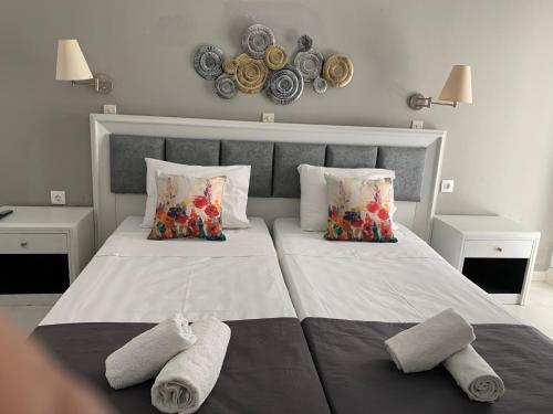 a bedroom with two beds with towels on them at Alkyonides Boutique Hotel in Kremasti