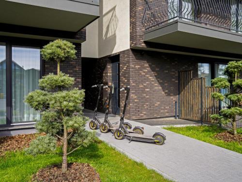 a scooter parked in front of a building at Apartamentai Saulėgrąža in Palanga