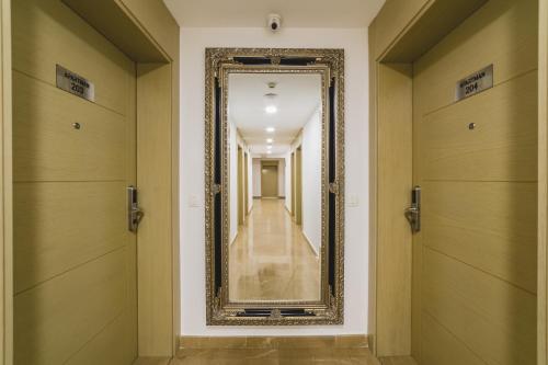a hallway with a mirror on the wall at Hotel 219 Budva in Budva