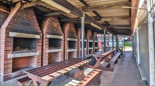 a row of benches on the side of a brick building at Scottburgh Views - Smile and Wave in Scottburgh