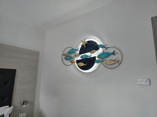 a clock hanging on a white wall in a room at Domo Annalisa in Tortolì
