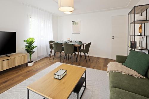 a living room with a couch and a table at STAYY Rigi Suites - Self-check-in Premium Apartments - 20min to Lucern - 7min Walk to Lake - Public Transport - Washer Dryer in Küssnacht