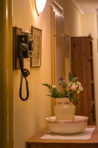 a phone is hanging on a wall in a bathroom at Historic Hotel Falken in Wengen