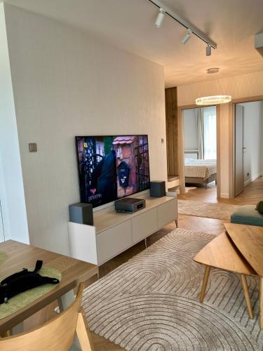 a living room with a flat screen tv on a wall at Apartament -Luksus- Nowa Dzielnica in Busko-Zdrój