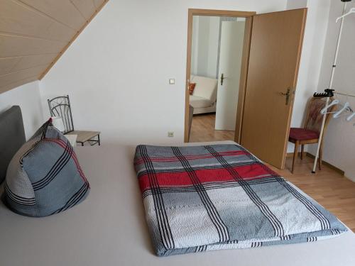 a bedroom with a bed with a blanket on it at Alte Spedition in Demmin